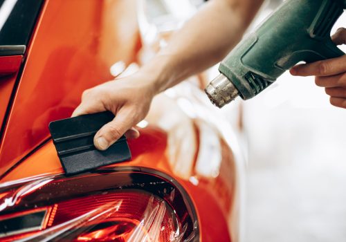 Car wrapping with foil and drying with fan at car service